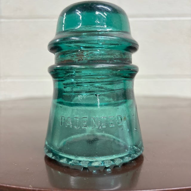 This is a gorgeous antique teal glass Hemingray insulator embossed “HEMINGRAY – Patented.”Produced by the Hemingray Glass...