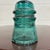This is a gorgeous antique teal glass Hemingray insulator embossed “HEMINGRAY – Patented.”Produced by the Hemingray Glass...