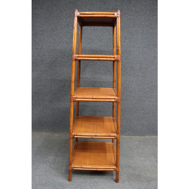 Ethan Allen faux bamboo etagere with four rattan shelves. Classic, lightweight look that works well for books, decor, or...