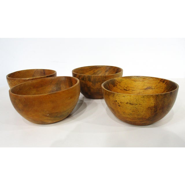 A set of four unique handcrafted organic mango wood serving or decorative bowls with fantastic graining. Designed and...