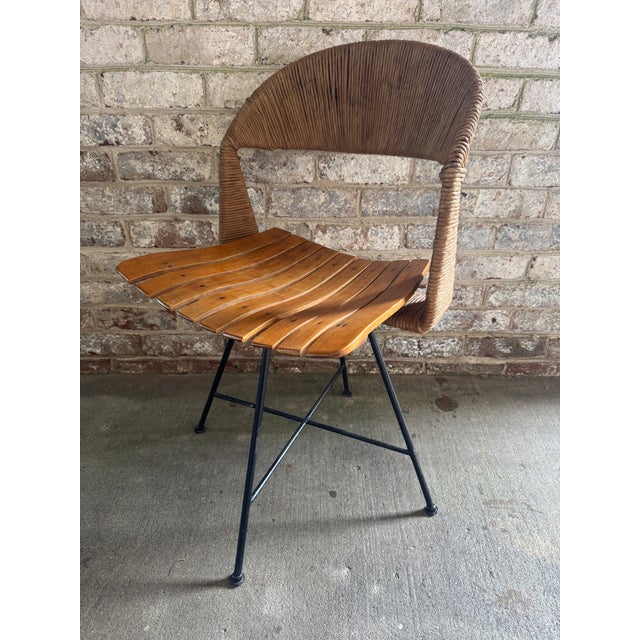 Arthur Umanoff swivel desk chair with signature rush back, slatted wood seat, and iron legs, 1950s. This chair is...