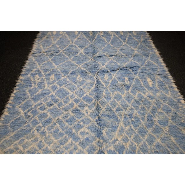 Comprising both the nomadic Berber rugs of the Atlas Mountains, with very thick piles, coarse knotting and limited...