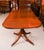 This is an elegant vintage Regency Revival three pillar dining table that can comfortably seat sixteen people and dates...