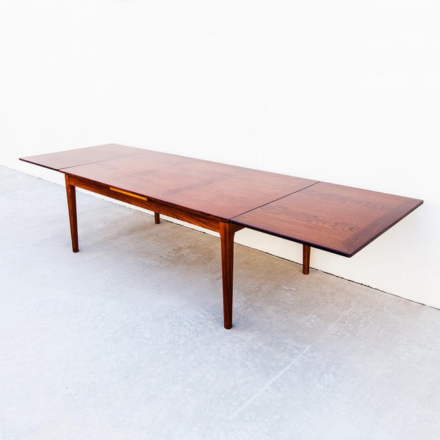 A very large expandable rosewood dining table by Skovby, made in Denmark c. 1970s and newly refinished. The surface...