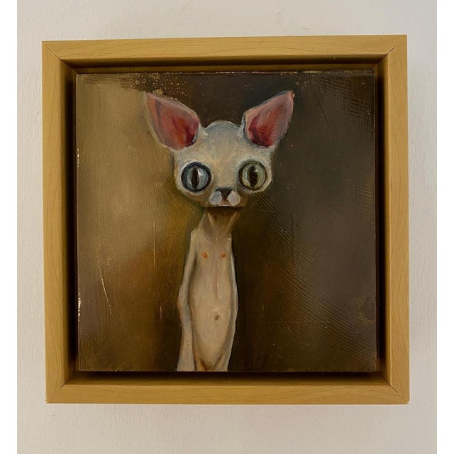 “Jenny” is a small but unforgettable gem by Michele Mikesell, a surreal, wide-eyed cat rendered in oil on board and framed...