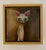 “Jenny” is a small but unforgettable gem by Michele Mikesell, a surreal, wide-eyed cat rendered in oil on board and framed...