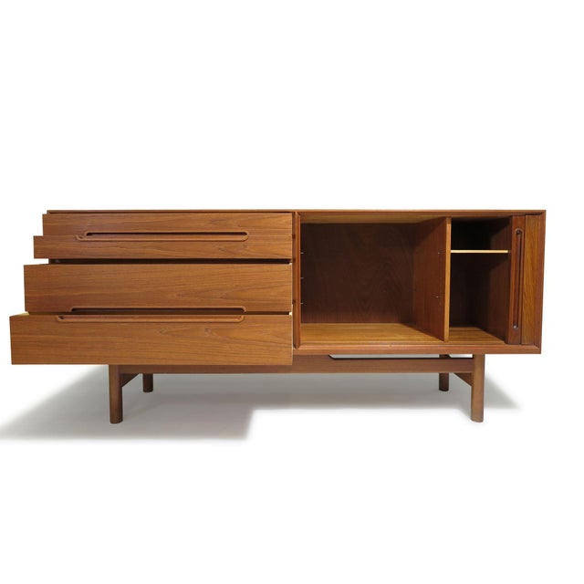 Scandinavian Modern teak credenza or sideboard designed by Nils Jonsson for Hugo Troeds, Sweden, circa 1960. This finely...