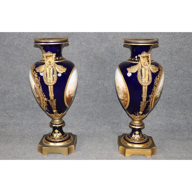 An absolute monumental and palatial pair of 19th-century French cobalt blue porcelain vases, beautifully attributed to the...