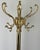 An elegant Vintage French brass standing coat hanger with an ornate traditional design, multiple curved hanging hooks and...