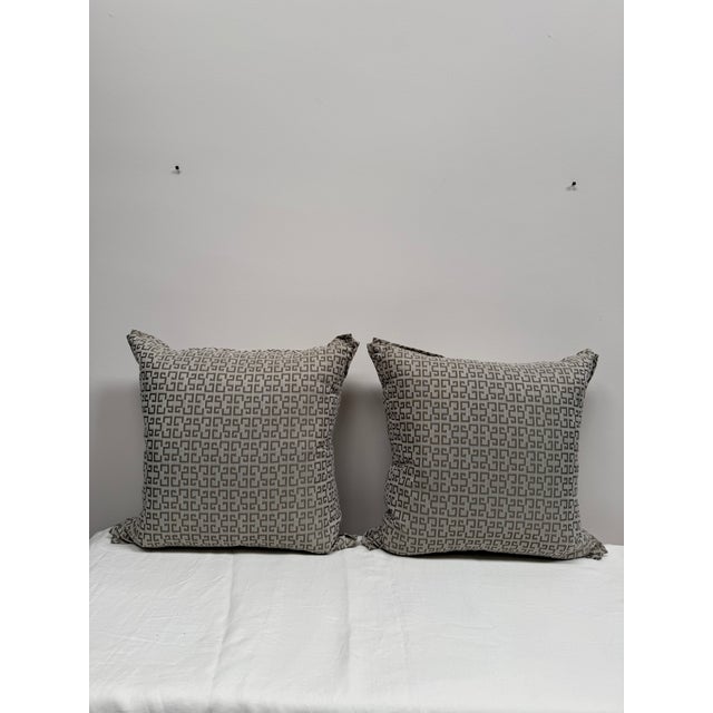 Pair of geometric print pillows. Down filled with unique pleat detail on the corners.