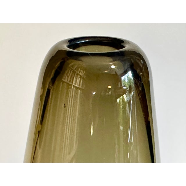 An impressive, thick-walled, smoked glass vase in the style of Wilhelm Wagenfeld or Heinrich Löffelhardt from the 1960s....
