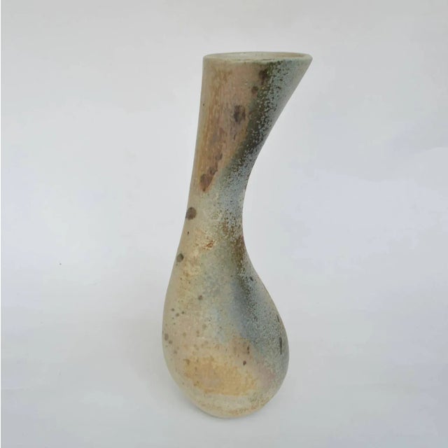 Curvaceous and organic hand formed vase glazed in muted tones.