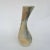 Curvaceous and organic hand formed vase glazed in muted tones.