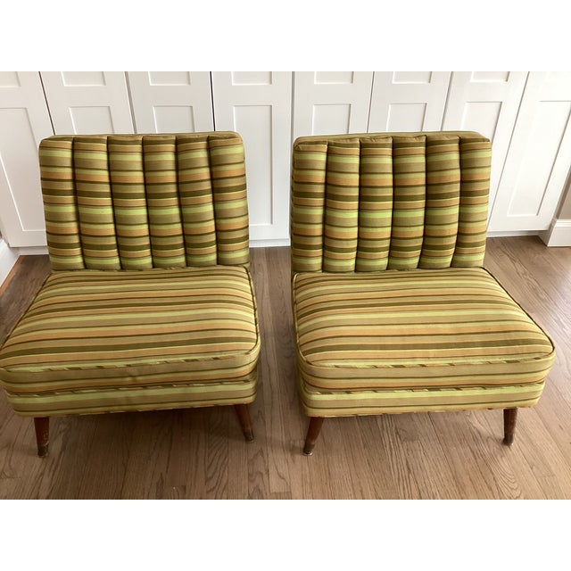 This stunning pair of midcentury modern slipper chairs are upholstered in classic 1960s colors of shades of avocado and...