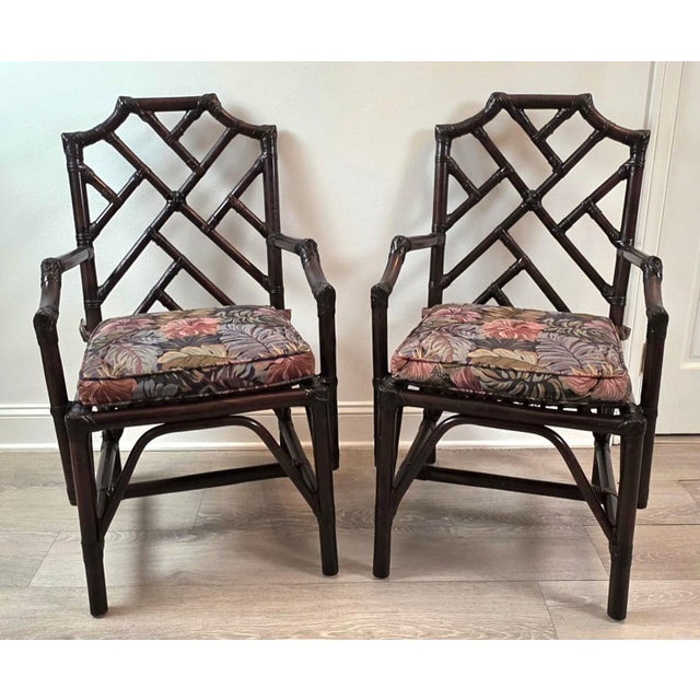 A vintage pair of Chinese Chippendale bamboo & rattan armchairs. Features open fretwork detail with a rich chocolate...