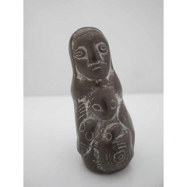 Traditional South American hand-carved stone Pachamama figurine. Depcicts a hooded figure with carvings and incised white...