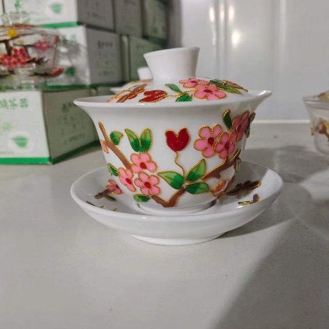 This is a charming vintage lidded teacup and saucer set, known as a gaiwan, attributed to the "export creation" period of...