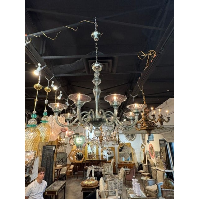 The Murano Fontana Green 8-light Chandelier is a stunning piece of lighting that adds a touch of elegance and...