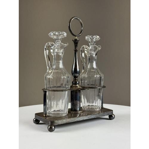 Silver-plated metal oil and vinegar set. Beautiful color and patina. Decanters in good condition! Dimensions: 30H x 23W x 10D