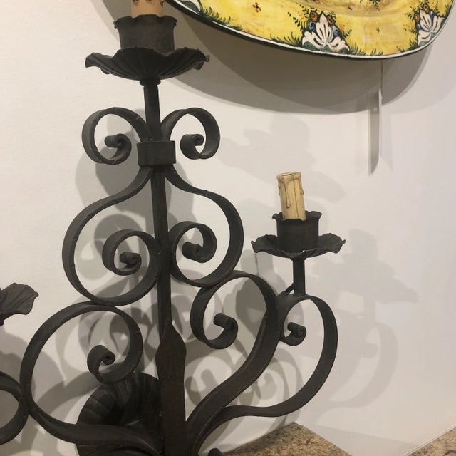 Three light wrought iron sconce with scroll design in a rustic finish. Italy.