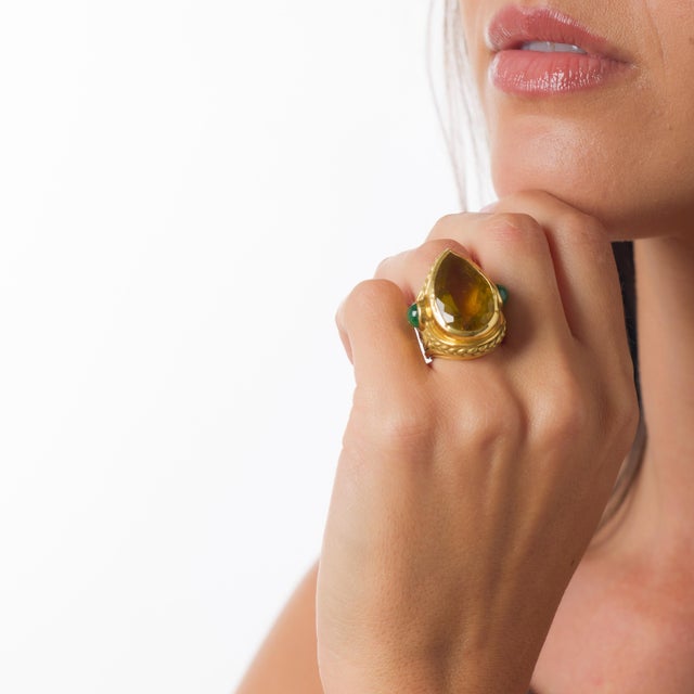 This bold vintage ring is a radiant celebration of color, scale, and confident 1970s design. At its center rests an...