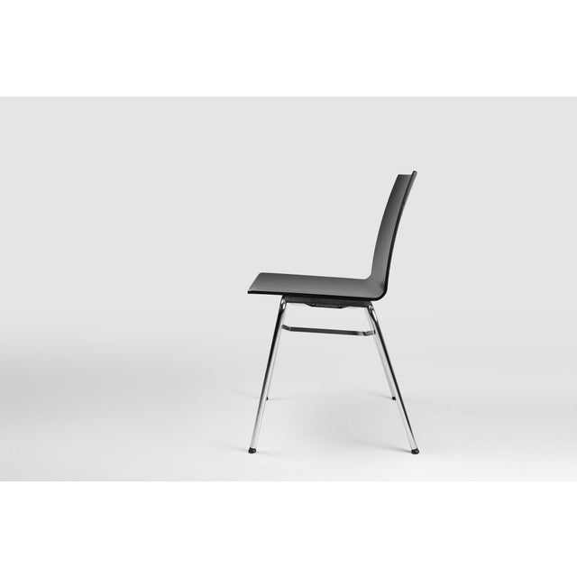 A sleek designed multi-functional design chair with wooden seat and metal frame. with its discreet, light and...