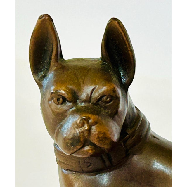 Bronze French bulldog figurine, featuring a rich brown patina and a detailed collar around the neck.