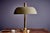 This vintage table lamp, designed by the renowned Hillebrand Lighting in the 1960s, features a brass stem and base,...