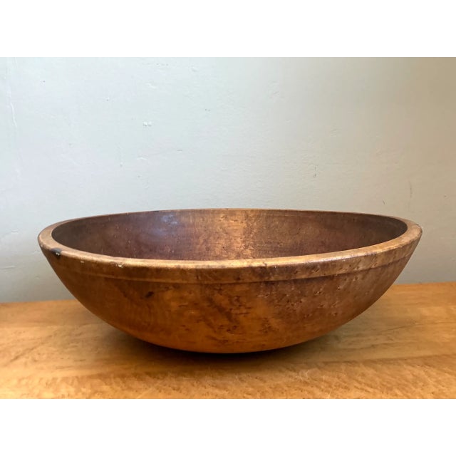 Hand-turned from solid hardwood with generous scale and rustic character, this large vintage bowl features a broad,...