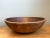 Hand-turned from solid hardwood with generous scale and rustic character, this large vintage bowl features a broad,...