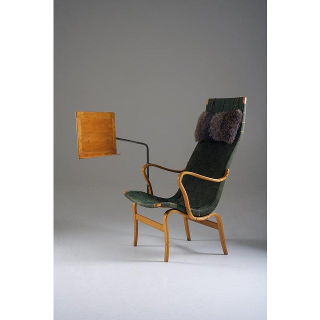Rare “Eva” easy chair designed by Bruno Mathsson, featuring its original green webbing — a colour seldom encountered — and...