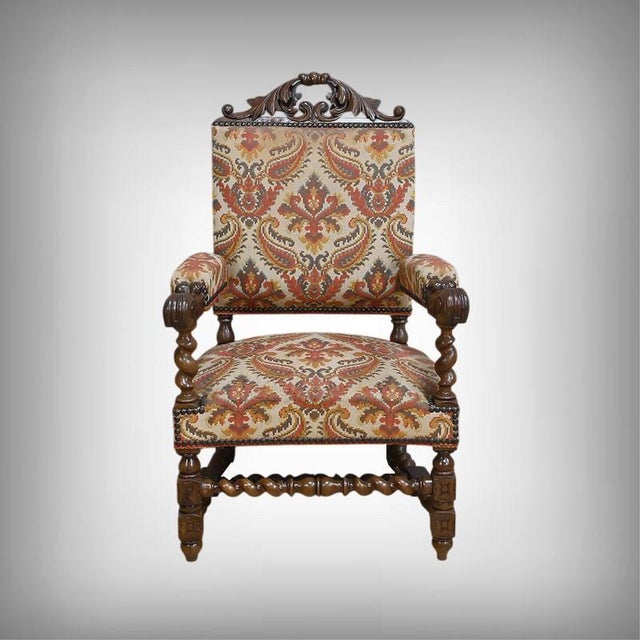 This upholstered oak armchair embodies the nobility and architectural rigor of the Louis XIII style. Its upright...