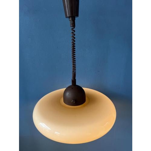 UFO acrylic glass space age pendant lamp by Herda in beige 'coffee' colour. The acrylic glass shade produces a warm glow....
