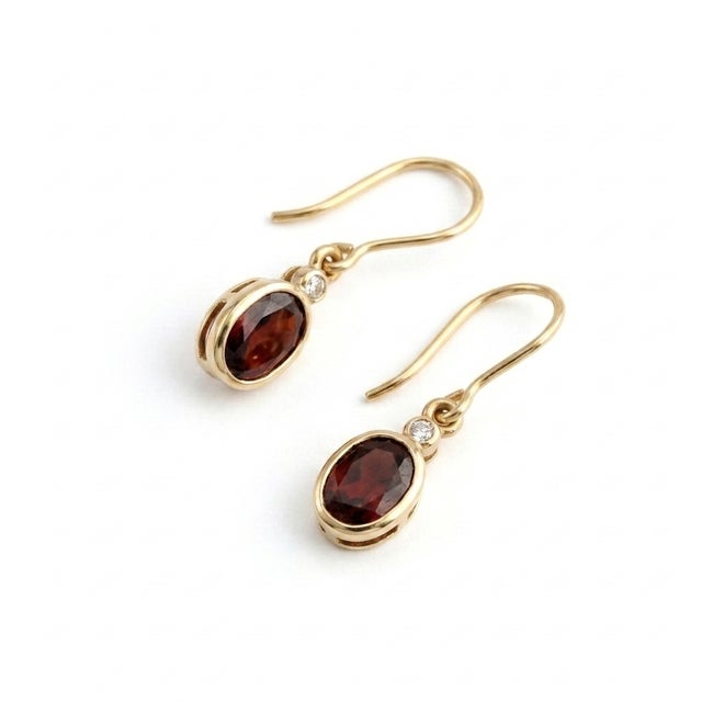 Add a touch of refined vintage elegance to your look with these breathtaking garnet drop earrings. Each earring features a...