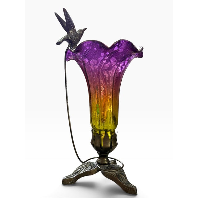 Beautiful vintage table lamp featuring a dramatic hand-blown style art glass flower shade in saturated purple, amber, and...