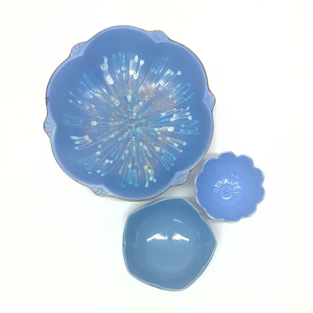 Chalky blue ceramic bowls, group of 3. A group of floral motif chalky blue ceramic serving bowls from the mid-20th...