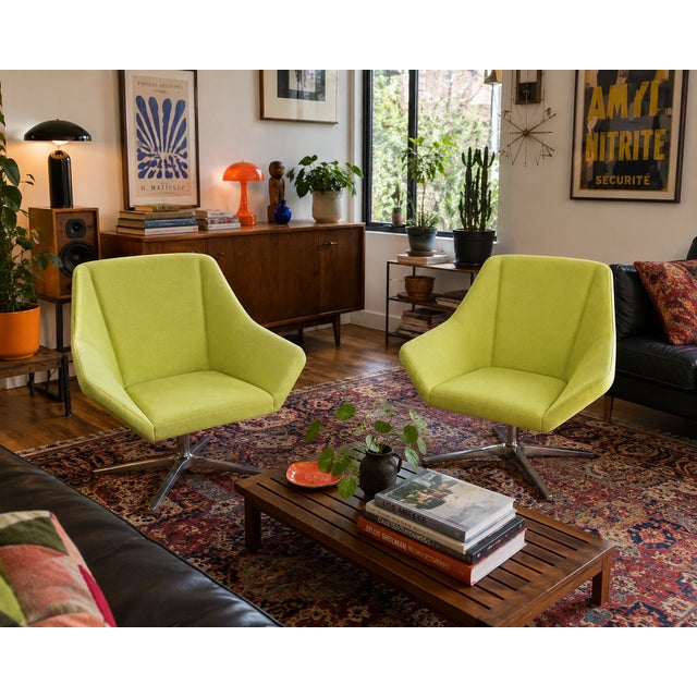 Pair of authentic Keilhauer Cahoots swivel lounge chairs in a striking lime green upholstery. Designed in collaboration...