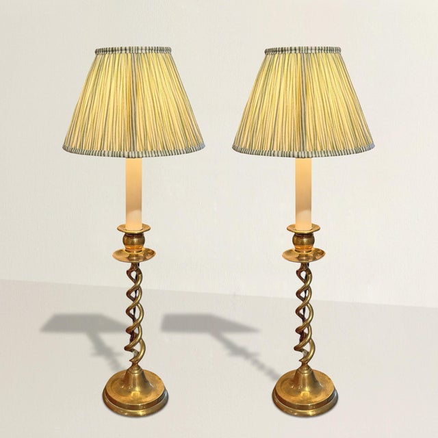 You do not need these lamps. That is the luxury. This pair of Georgian English brass barely twist candlesticks embodies...