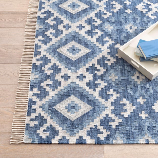 A series of repeating and interlocking patterns creates a beautifully dynamic and complex field in moody shades of faded...