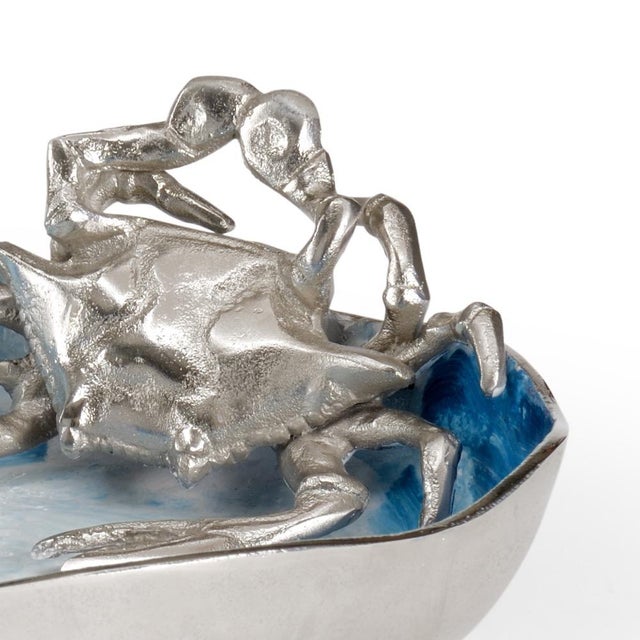 A blue and white surf like pattern bowl with a crab motif, designed for entertainment and decorative purposes for...