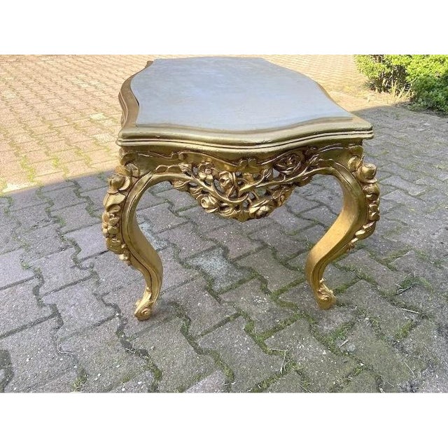 This elegant 1980s French Louis XVI–style coffee table combines a finely carved solid beechwood frame with a warm antique-...