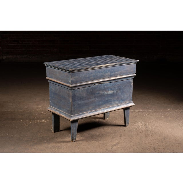 Blue-painted pine blanket chest raised on integral square legs with molded base and cornice, retaining its original lift-...