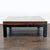 A dramatic square rosewood top with pronounced wood grain, resting on four legs of ebonized oak. Christian Liaigre...