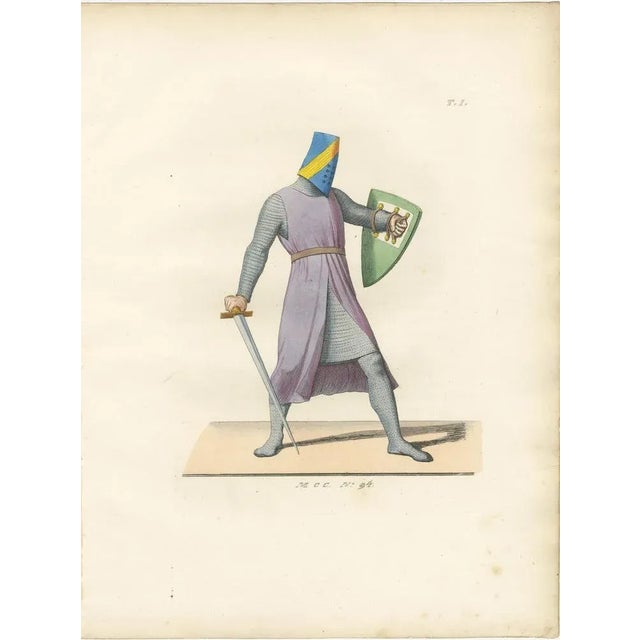 Medieval Knight in Chainmail with Bascinet and Sword, circa 13th Century This striking antique costume print, labeled...