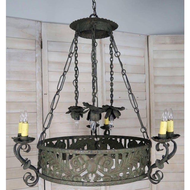 19th century Spanish wrought iron circular chandelier. Six lights in three pairs of two with drip wax candle covers held...