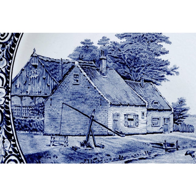 A Belgian delft platter or wall plate made by Boch for Royal Sphinx Holland. Decorated with a bucolic Dutch scene...