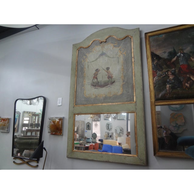 18th Century French Louis XVI Boiserie Trumeau Mirror. This stunning 18th century French boiserie trumeau depicts two...