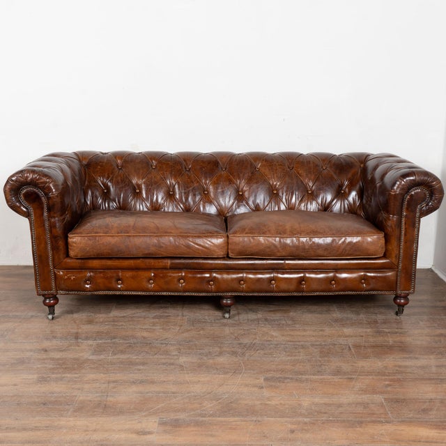 The rich brown vintage leather captures your attention in this wonderful Chesterfield sofa standing just over 7' long. It...