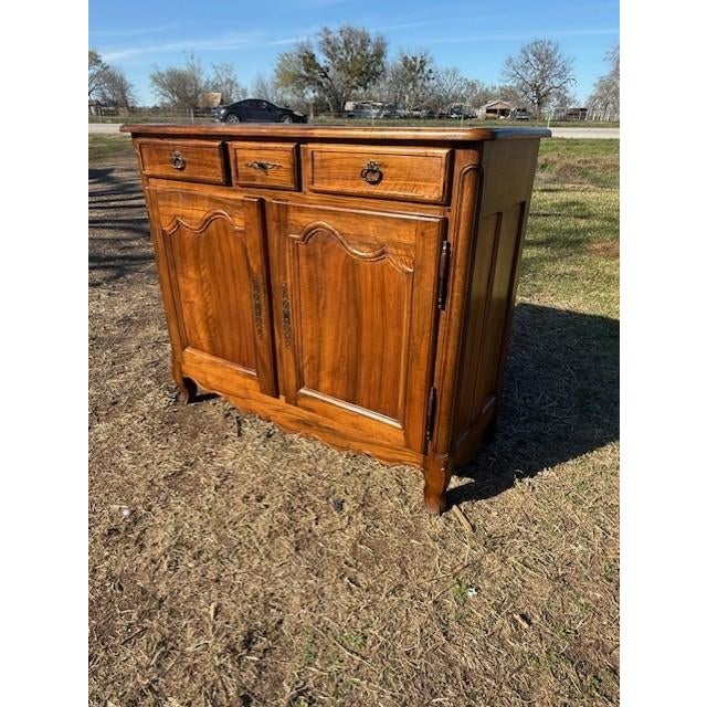 19th Century French country Louis XV Solid Walnut sideboard made of solid walnut the wood has been finished with a...