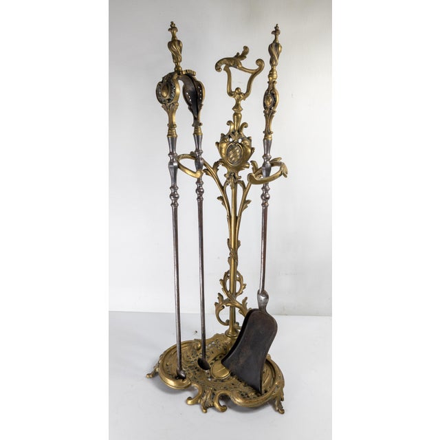 We are selling this beautiful set of Rococo Revival bronze fireplace tools and holder. This set includes the base, an ash...